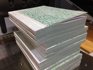 A stack of triplicate NCR docket books